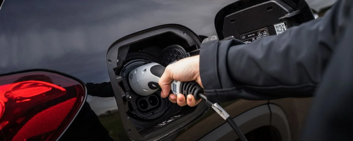 Man charging electric Mercedes-Benz EQA